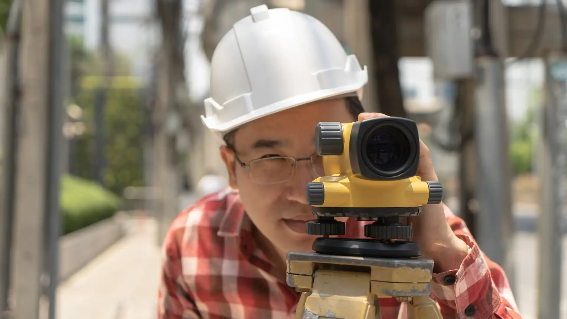 Types of land surveying – Worker using surveying equipment