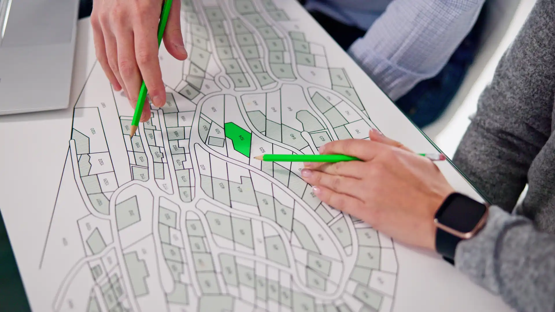 Two people reading a land survey report
