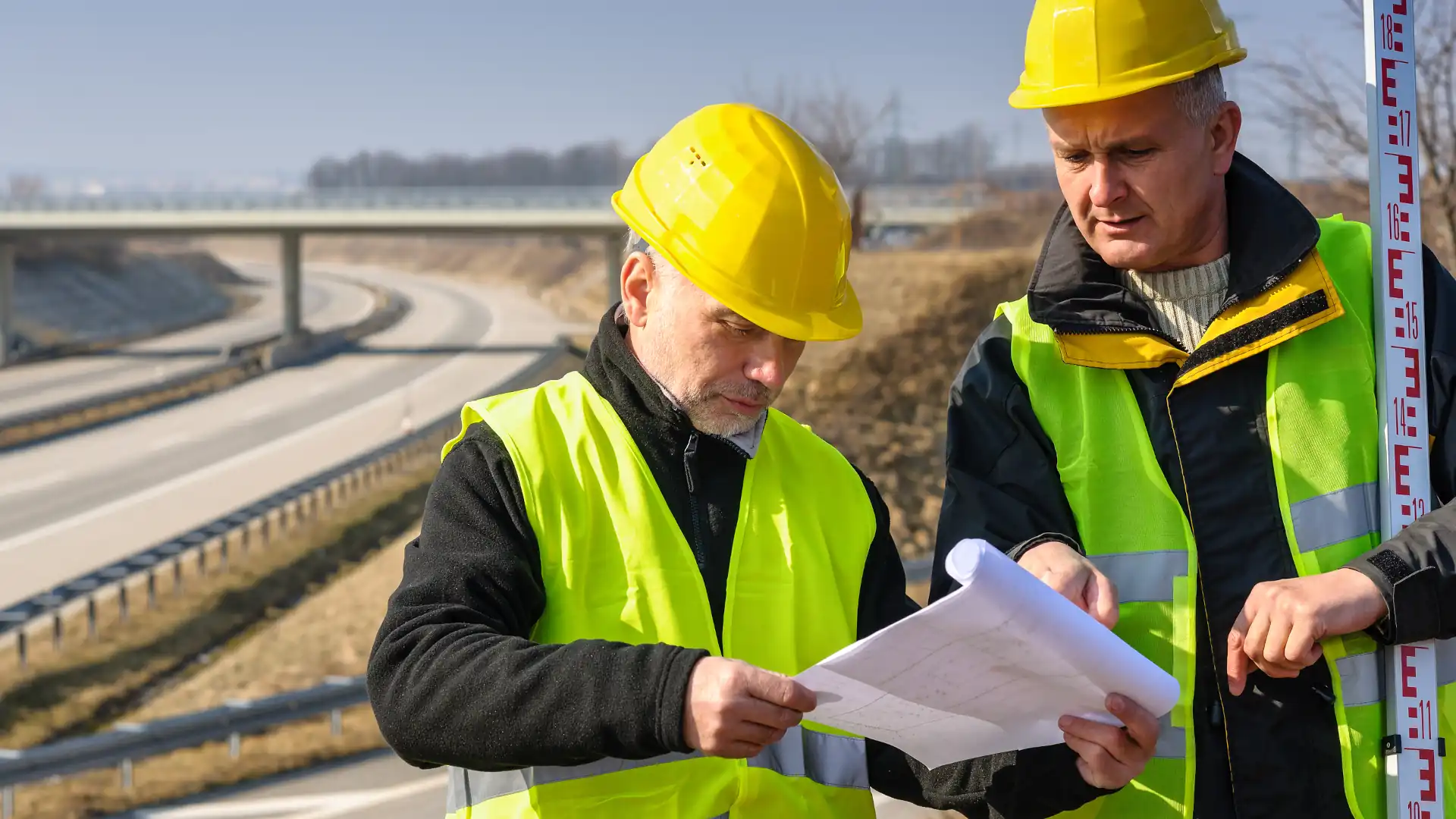  Role of land surveyor - Surveyors looking at plans