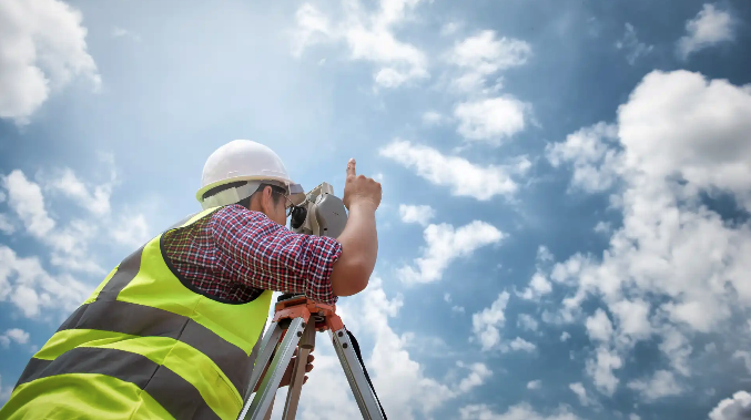 How much does a land survey cost – Worker using survey equipment