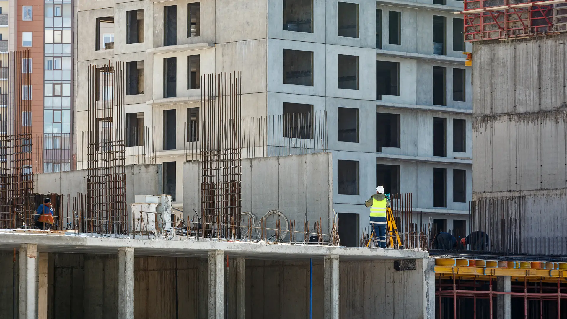 Surveyor checking foundations at a medium-density development - unit titles NZ