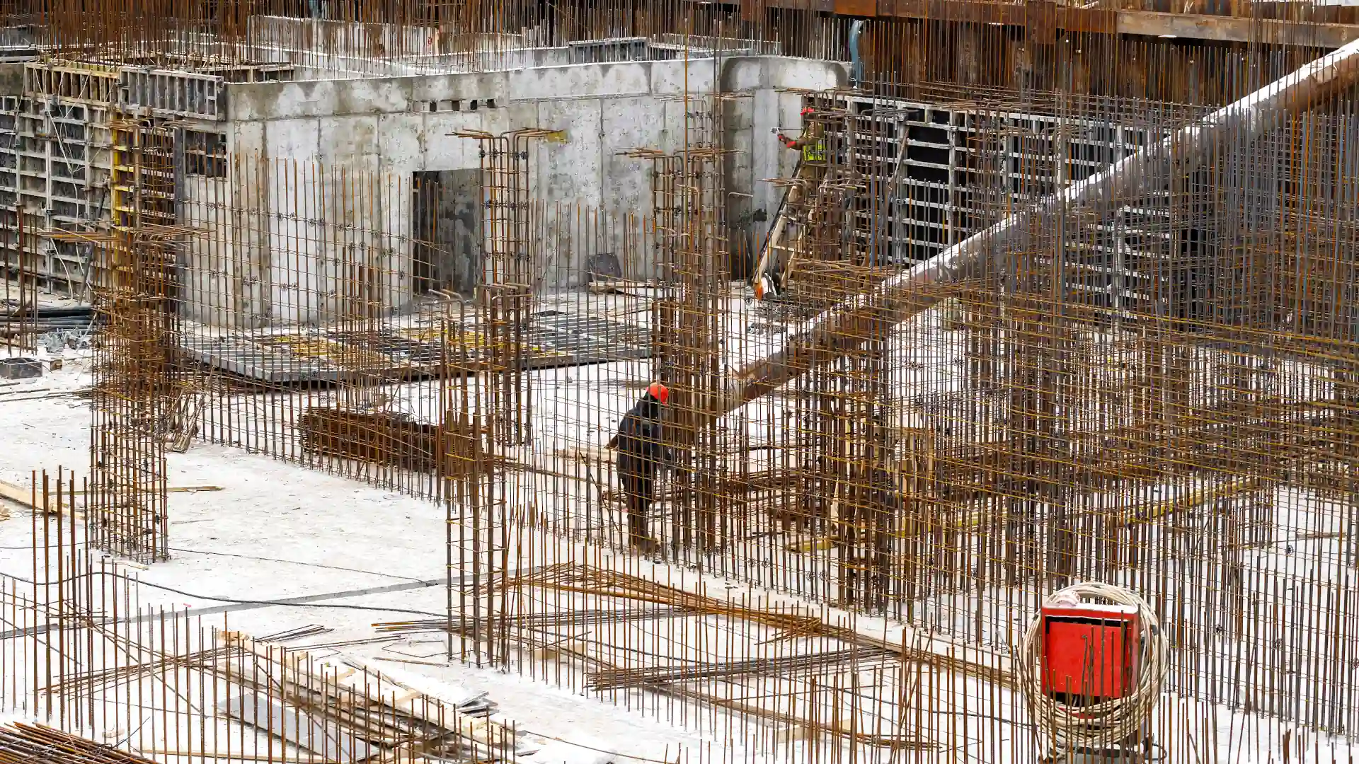 Surveyor checking rebar at the start of residential construction - unit titles NZ