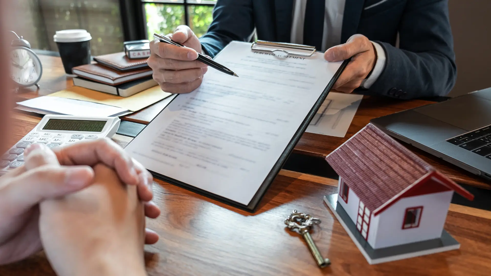 Lawyer reviewing property title documents with client in New Zealand